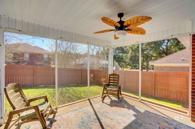 sunroom / solarium with ceiling fan, wooden ceiling, and a wealth of natural light