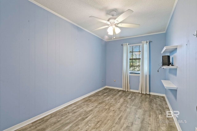 empty room featuring hardwood / wood-style flooring, ceiling fan, crown molding, and a textured ceiling