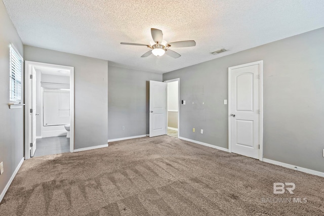 unfurnished bedroom with ceiling fan, carpet floors, a textured ceiling, and connected bathroom