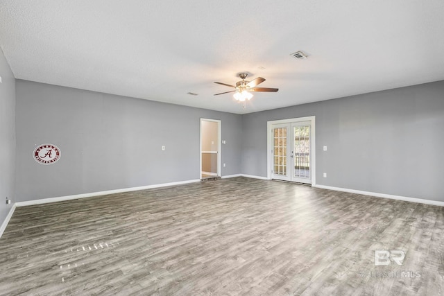 unfurnished room featuring french doors, wood-type flooring, a textured ceiling, and ceiling fan