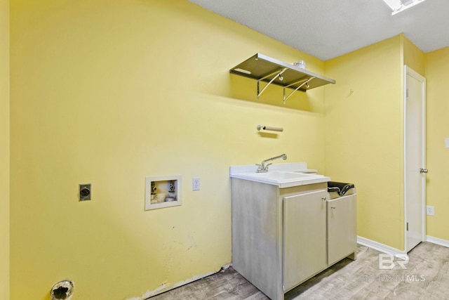 laundry room featuring hookup for an electric dryer, cabinets, light wood-type flooring, and hookup for a washing machine