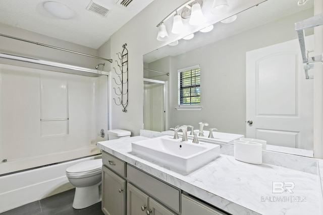 full bathroom with toilet, vanity, a textured ceiling, and combined bath / shower with glass door