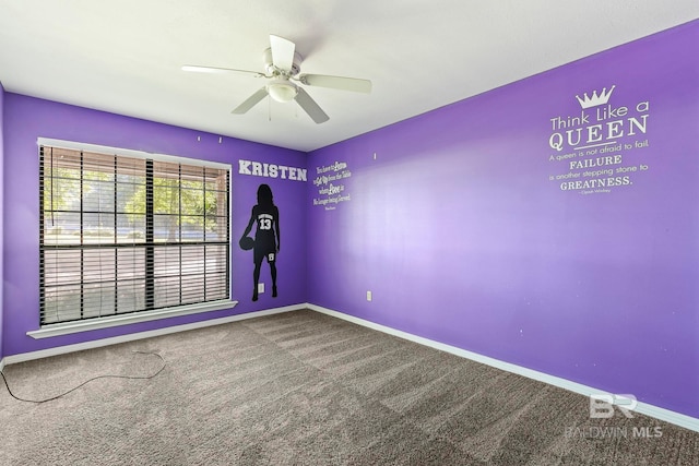 empty room featuring ceiling fan and carpet floors