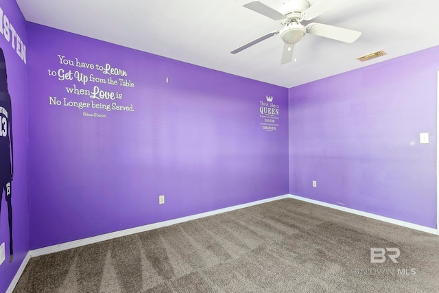 unfurnished room featuring ceiling fan and carpet floors