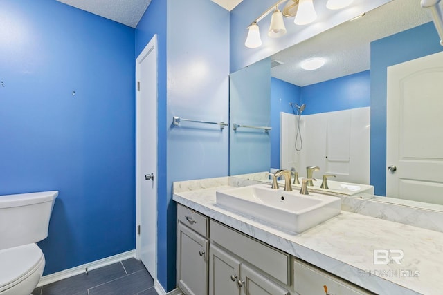 bathroom featuring vanity, toilet, a textured ceiling, and walk in shower