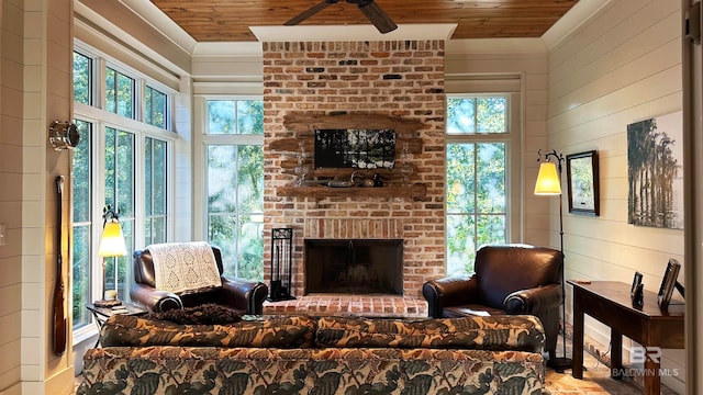 living room with wood ceiling, ceiling fan, wooden walls, and a brick fireplace