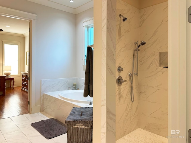 bathroom with crown molding, hardwood / wood-style floors, and independent shower and bath