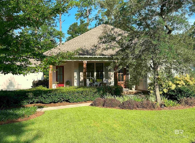 view of front of home with covered porch and a front yard