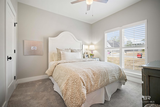 carpeted bedroom featuring multiple windows and ceiling fan