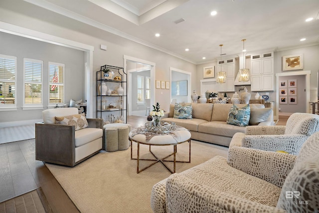 living room with wood-type flooring and crown molding