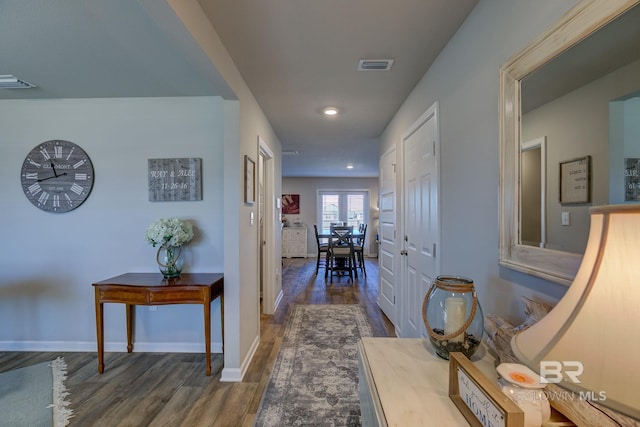 hallway with dark hardwood / wood-style flooring