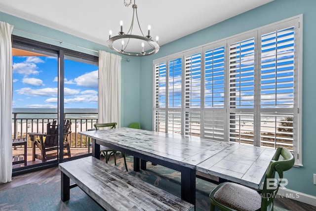 25250 Perdido Beach Blvd Unit 304E, Orange Beach, AL 36561 - dining room featuring an inviting chandelier, wood finished floors, baseboards, and a water view