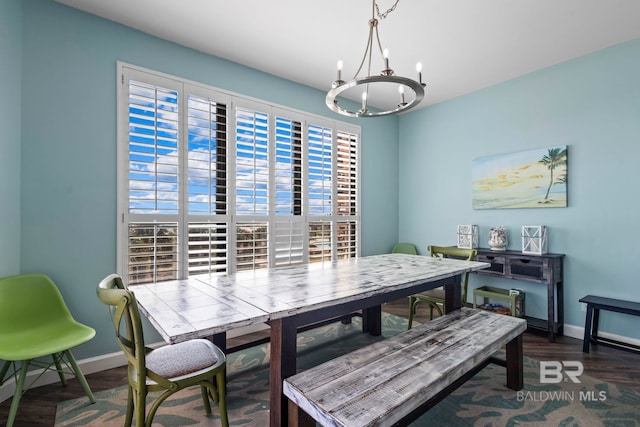 25250 Perdido Beach Blvd Unit 304E, Orange Beach, AL 36561 - dining space featuring wood finished floors, baseboards, and a chandelier