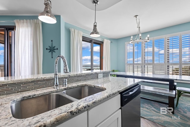 25250 Perdido Beach Blvd Unit 304E, Orange Beach, AL 36561 - kitchen featuring a notable chandelier, a sink, decorative light fixtures, stainless steel dishwasher, and white cabinets