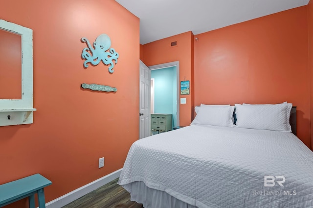 25250 Perdido Beach Blvd Unit 304E, Orange Beach, AL 36561 - bedroom with visible vents, baseboards, and wood finished floors