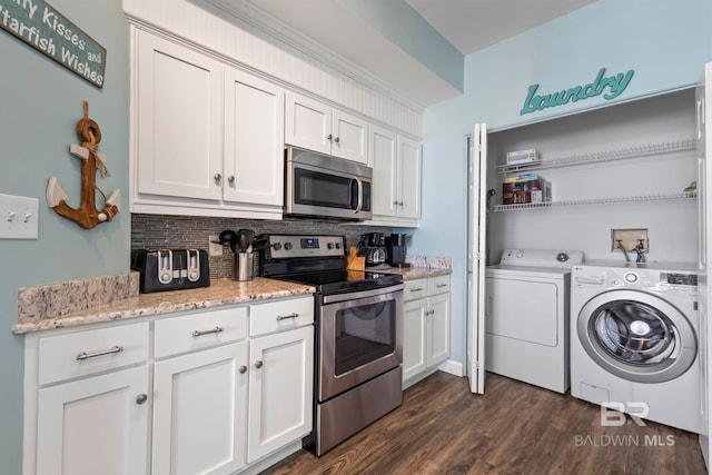 25250 Perdido Beach Blvd Unit 304E, Orange Beach, AL 36561 - kitchen featuring washing machine and clothes dryer, white cabinetry, stainless steel appliances, and dark wood-type flooring