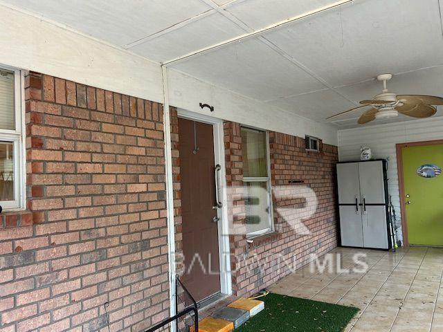 entrance to property featuring ceiling fan