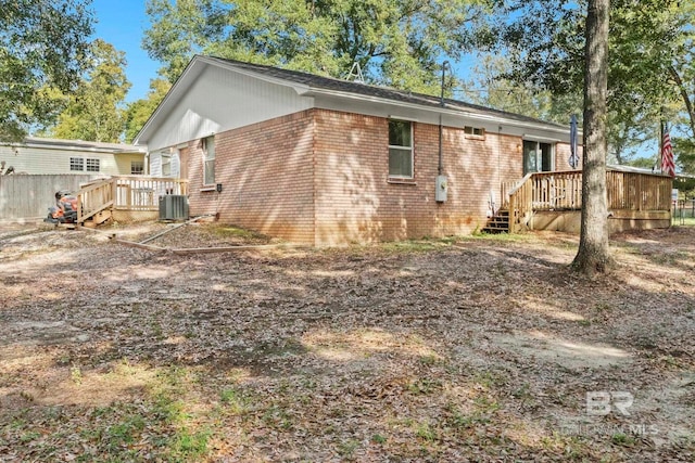 back of house featuring a wooden deck and cooling unit