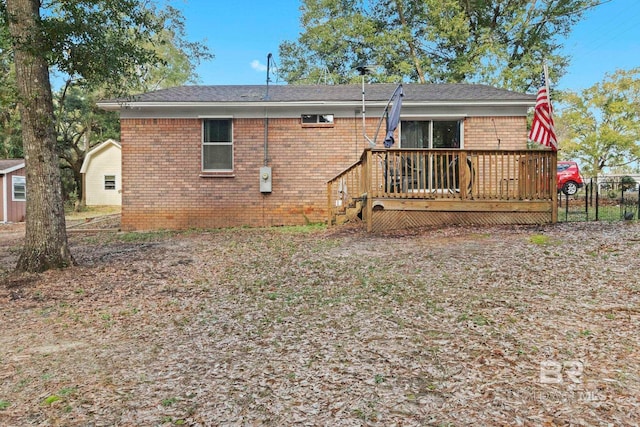 back of property with a wooden deck