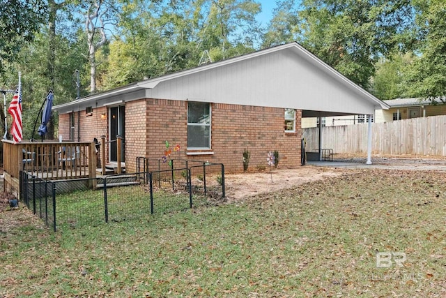 back of property featuring a deck and a yard