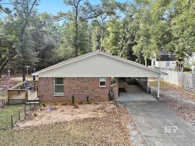 view of side of property with a wooden deck and a carport