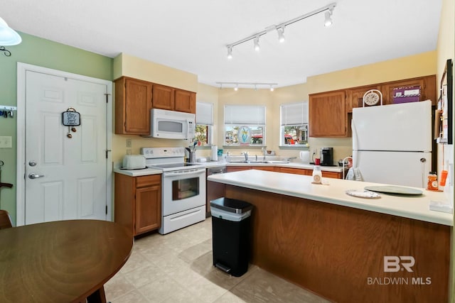 kitchen featuring sink and white appliances