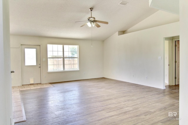 2555 W Ashford Park Dr, Foley, AL 36535 - unfurnished room with ceiling fan, light wood-style flooring, vaulted ceiling, a textured ceiling, and baseboards