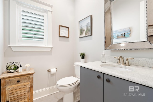 bathroom with vanity, tile patterned flooring, and toilet