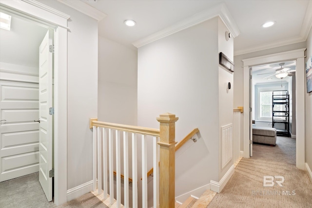 hallway featuring crown molding and light carpet