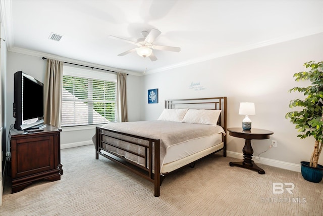 bedroom featuring ceiling fan, light colored carpet, and ornamental molding