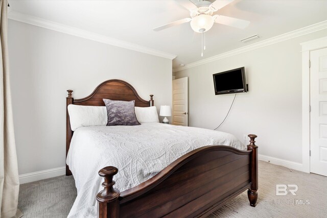 carpeted bedroom with ceiling fan and crown molding