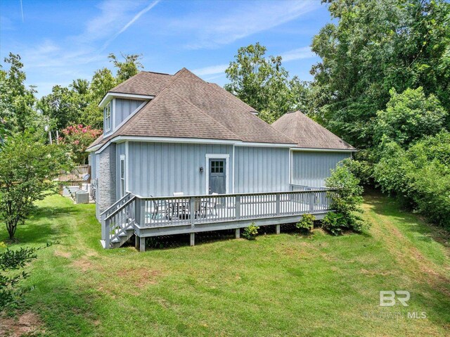 back of house with a lawn and a wooden deck