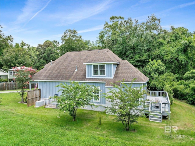 view of property exterior featuring cooling unit, a deck, and a lawn