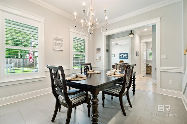 dining room with crown molding, tile patterned flooring, and ceiling fan with notable chandelier