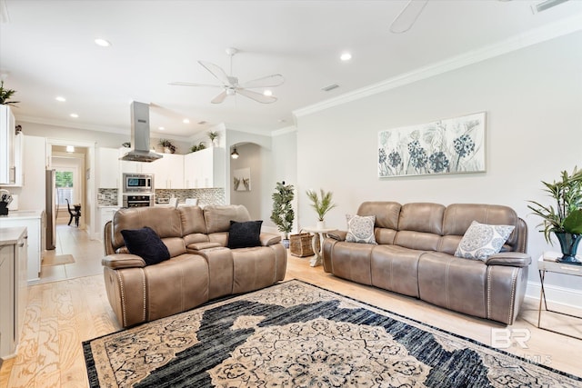 living room featuring light tile patterned flooring, crown molding, and ceiling fan