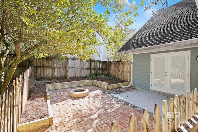 view of patio featuring french doors and a fire pit