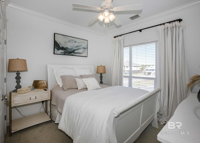 bedroom featuring a ceiling fan, visible vents, crown molding, and carpet flooring