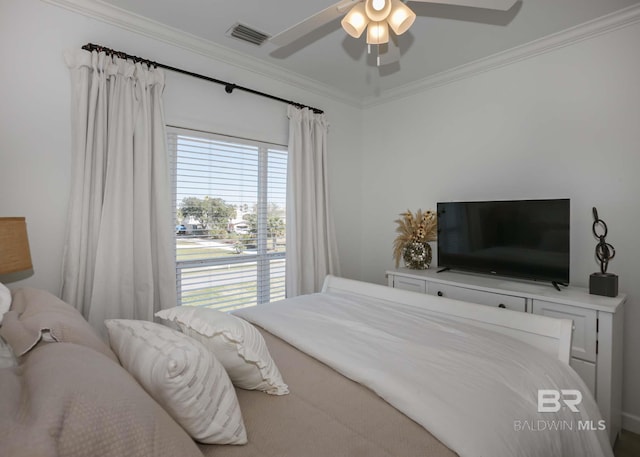 bedroom with a ceiling fan, visible vents, and crown molding