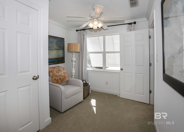 unfurnished room featuring baseboards, visible vents, ceiling fan, crown molding, and carpet floors