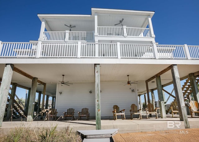 rear view of property featuring stairs, a patio, and a ceiling fan
