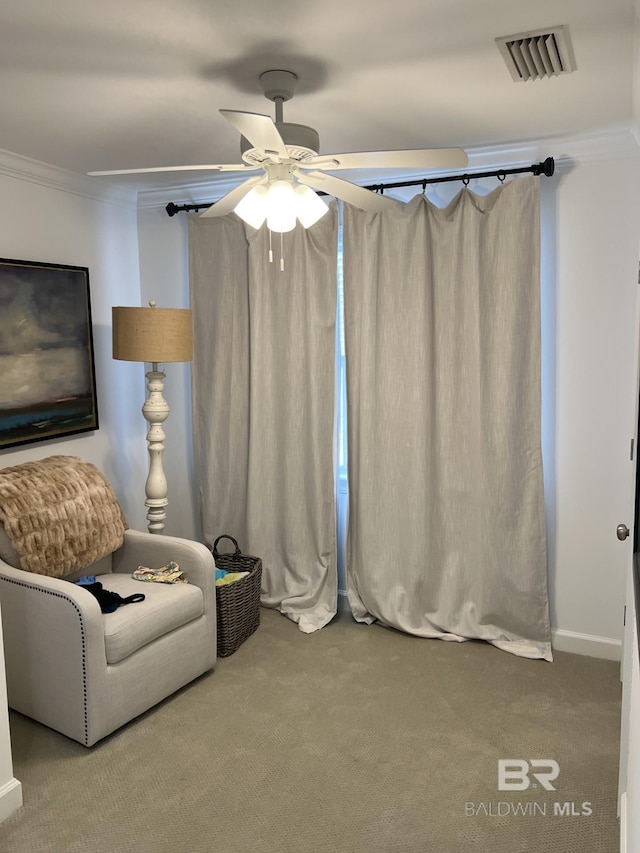 unfurnished room with carpet floors, visible vents, crown molding, and ceiling fan