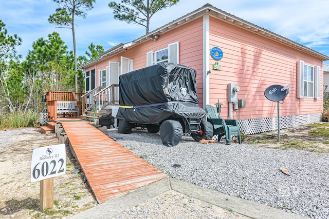 view of side of property featuring a deck