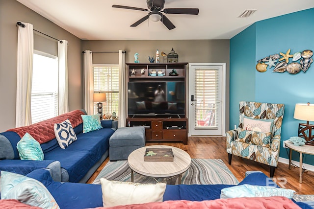 living room featuring ceiling fan and hardwood / wood-style flooring