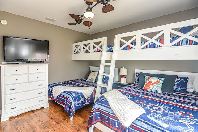 bedroom with ceiling fan and hardwood / wood-style floors