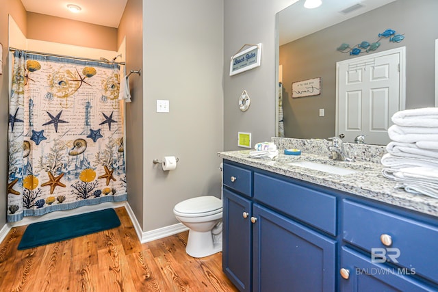 bathroom with a shower with curtain, vanity, hardwood / wood-style floors, and toilet