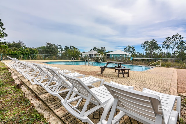 view of swimming pool featuring a patio area