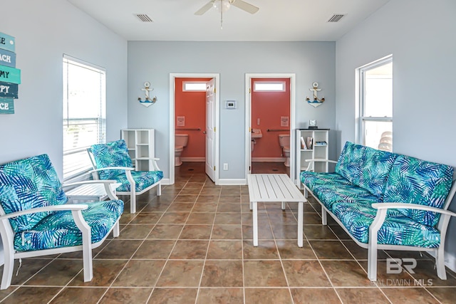 tiled living room featuring ceiling fan and plenty of natural light