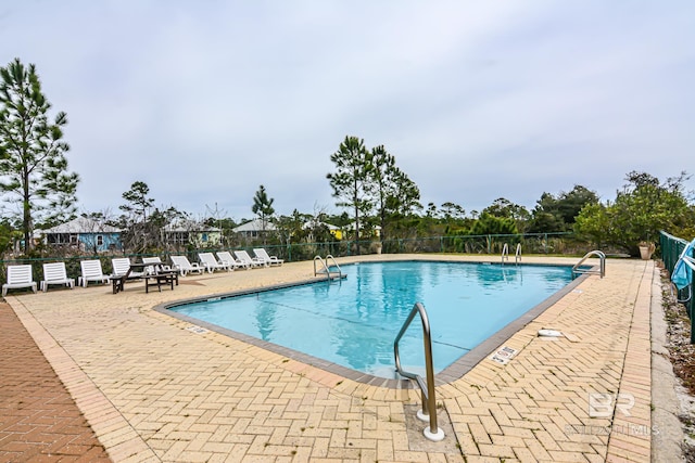 view of swimming pool with a patio