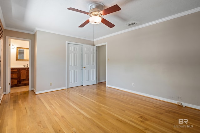 606 Fairhope Ave, Fairhope, AL 36532 - unfurnished bedroom with light wood-style flooring, baseboards, ornamental molding, a closet, and ensuite bath