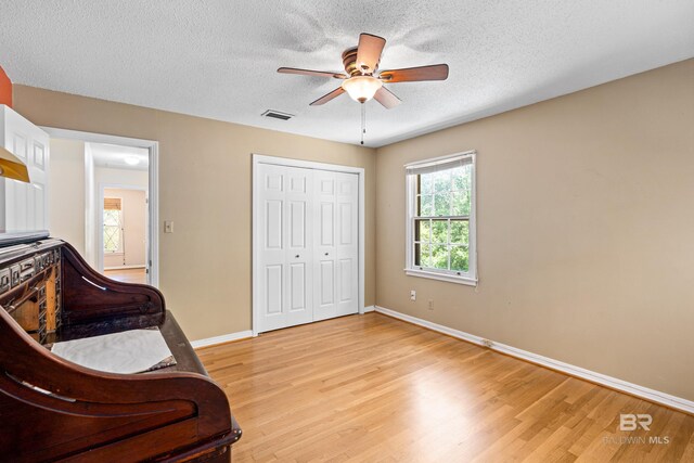 606 Fairhope Ave, Fairhope, AL 36532 - sitting room with ceiling fan, light wood-style floors, baseboards, and a textured ceiling